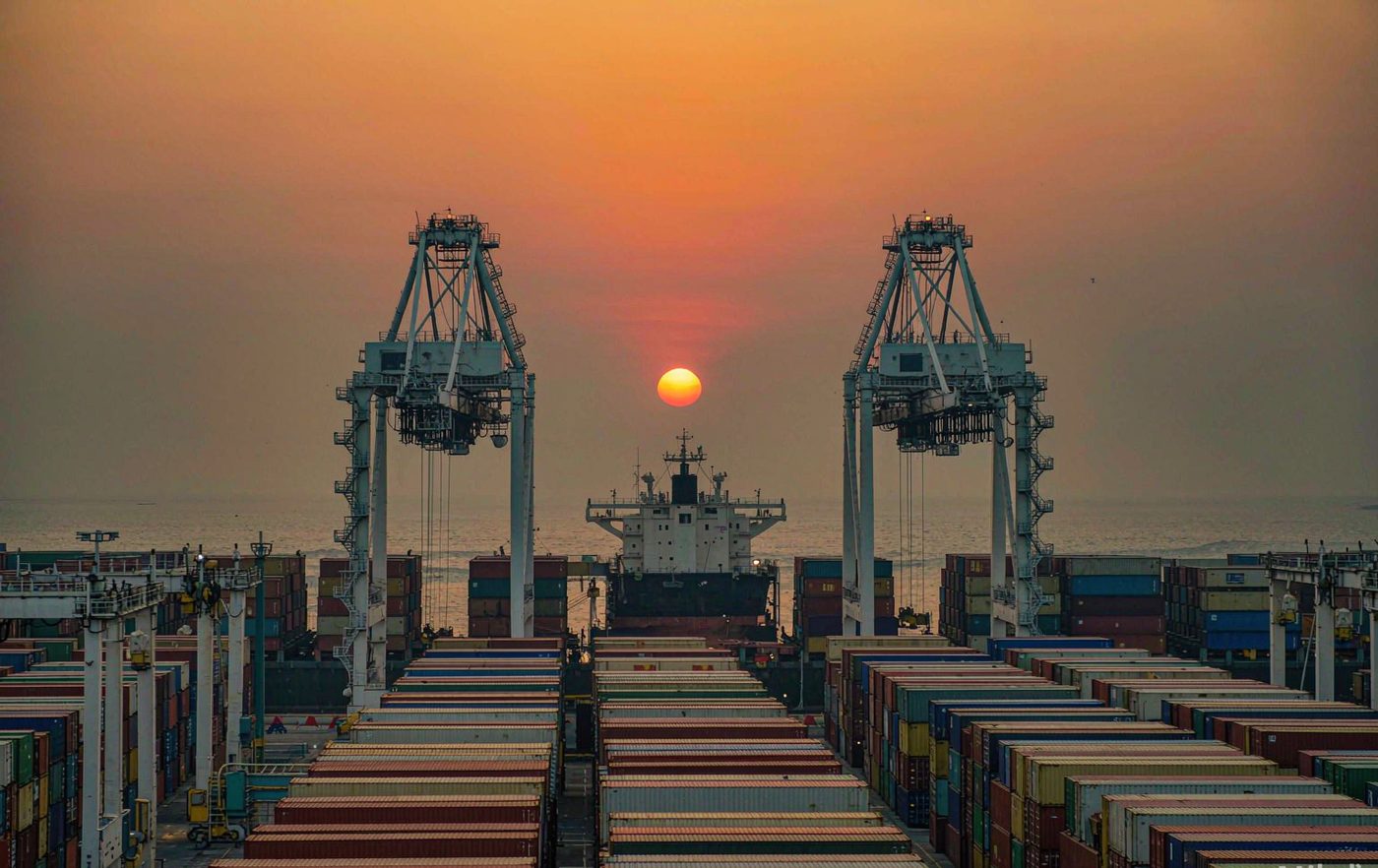 Container terminal at dusk - export sea freight for caustic soda flakes